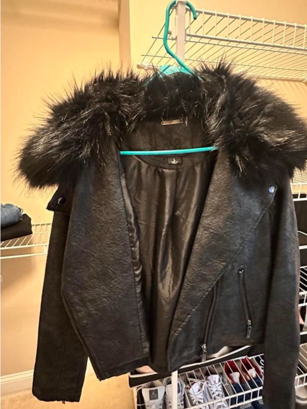Black Victoria’s Secret faux leather jacket with a large faux fur hood/collar